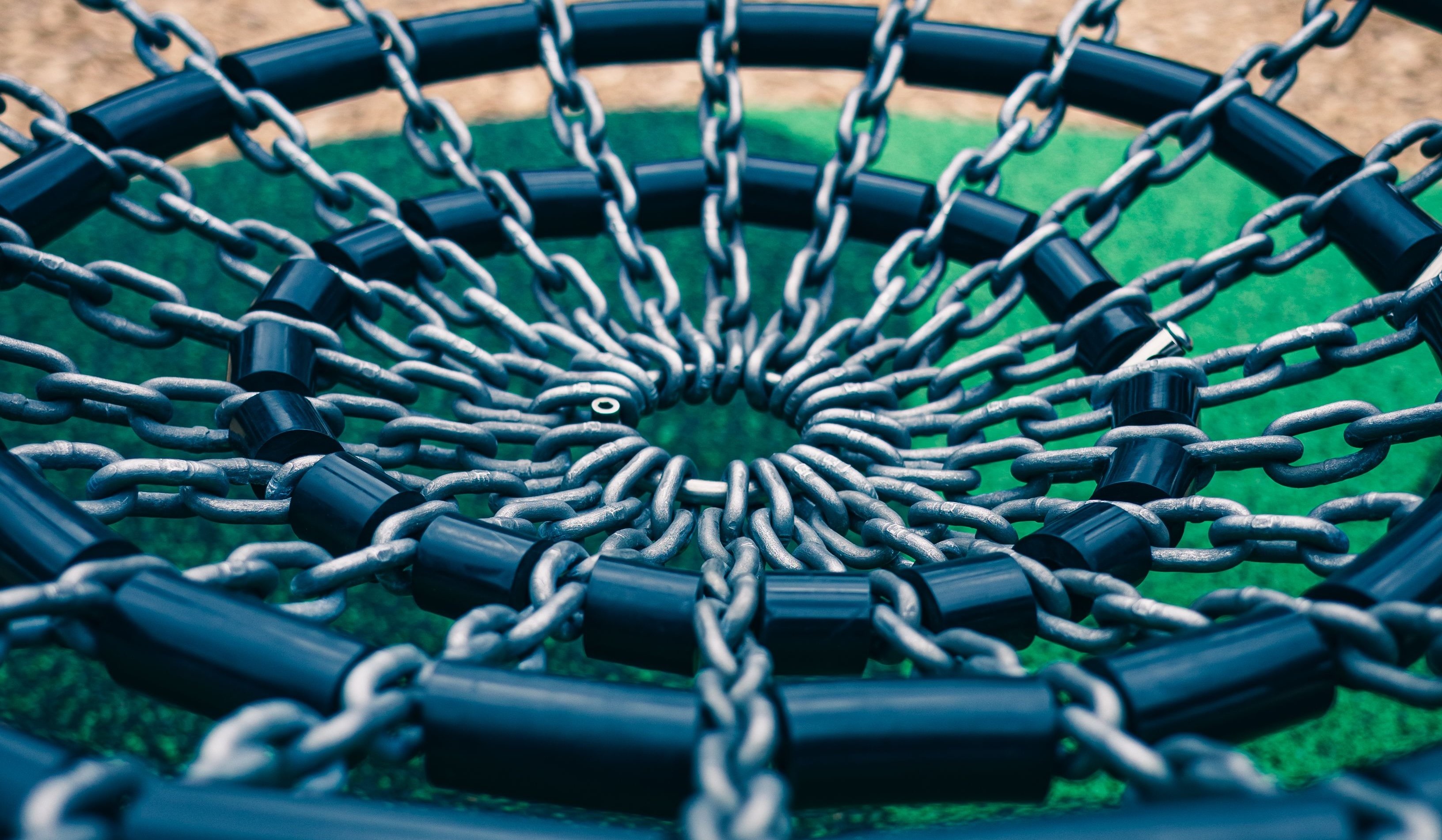 Two dozen chains connected to a central ring branching out in all directions with black concentric circles connecting them every four links out from the center.